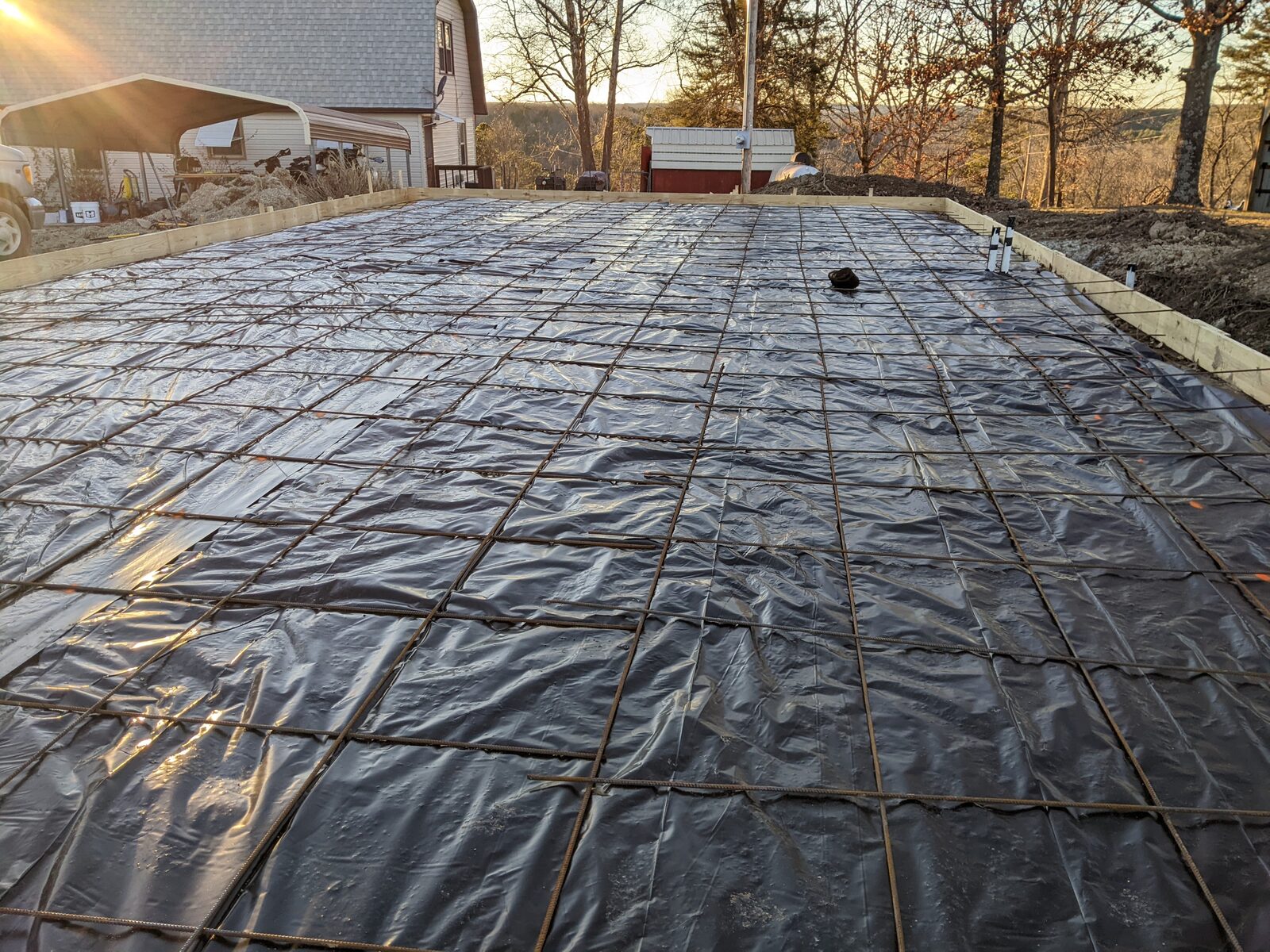 Vapor barrier and rebar grid prepped for a concrete slab pour