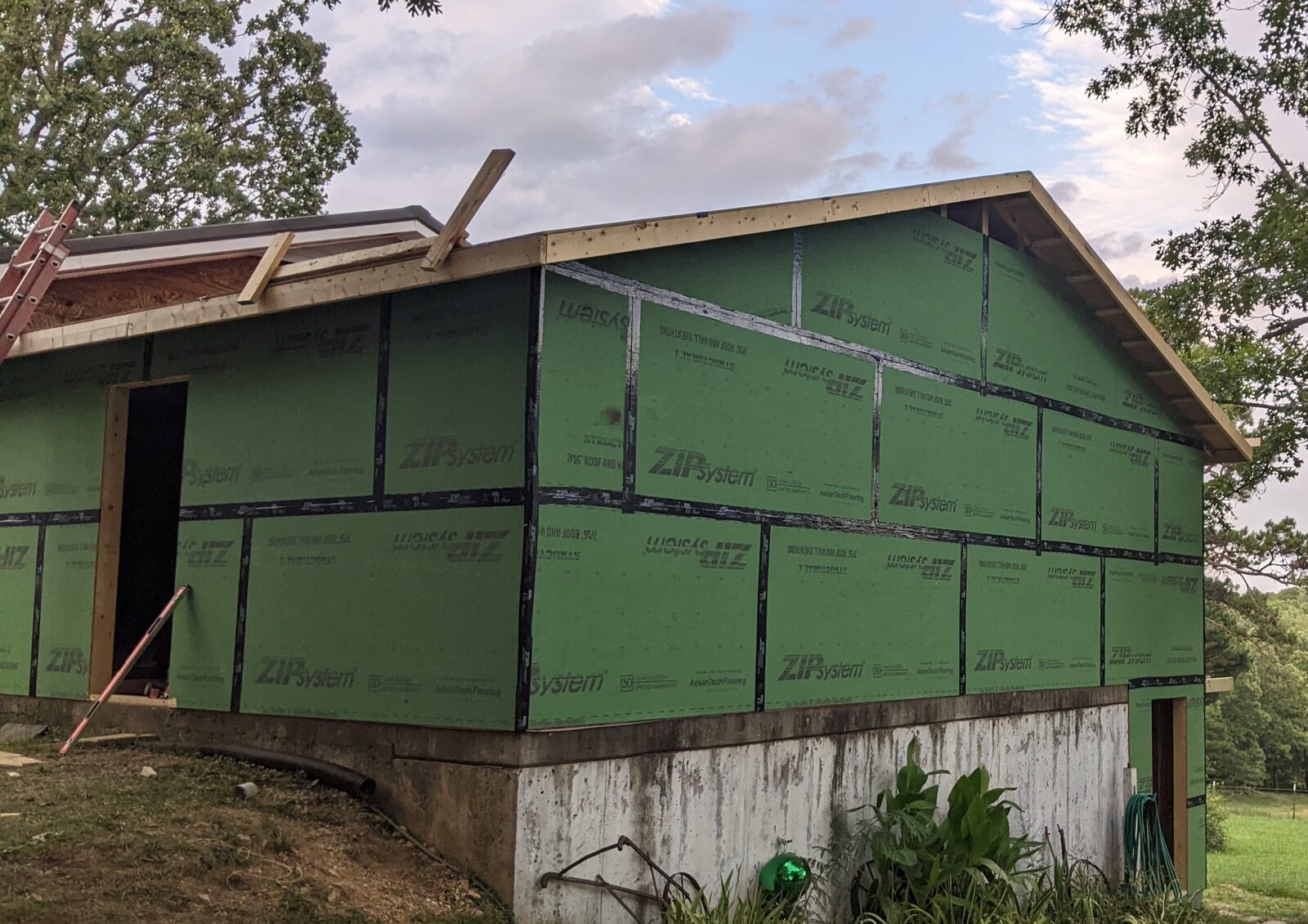 House under construction with green ZIP System sheathing on exterior walls